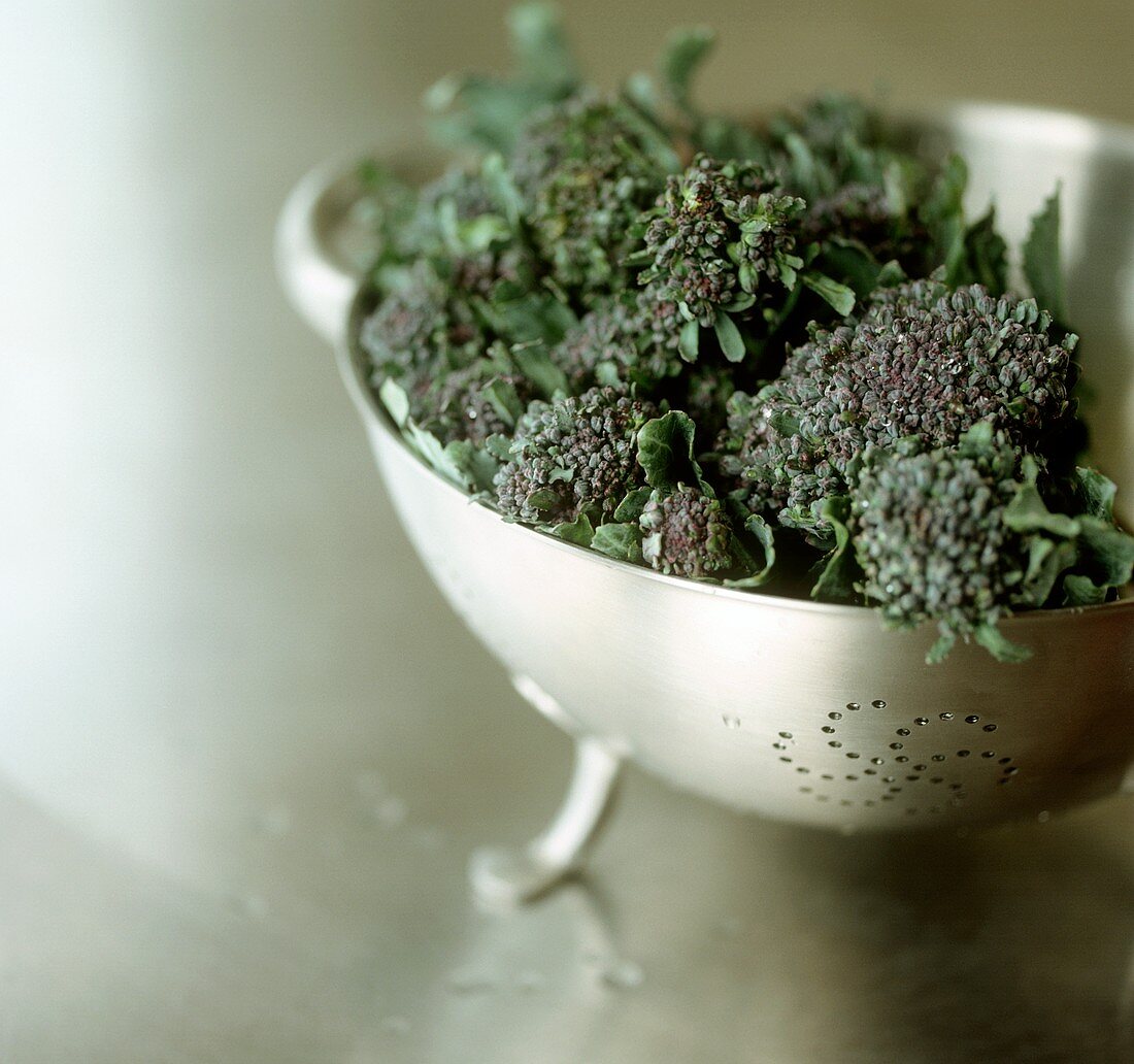 Purple broccoli in sieve