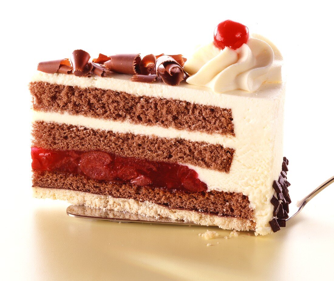 A piece of Black Forest cherry gateau on cake slice