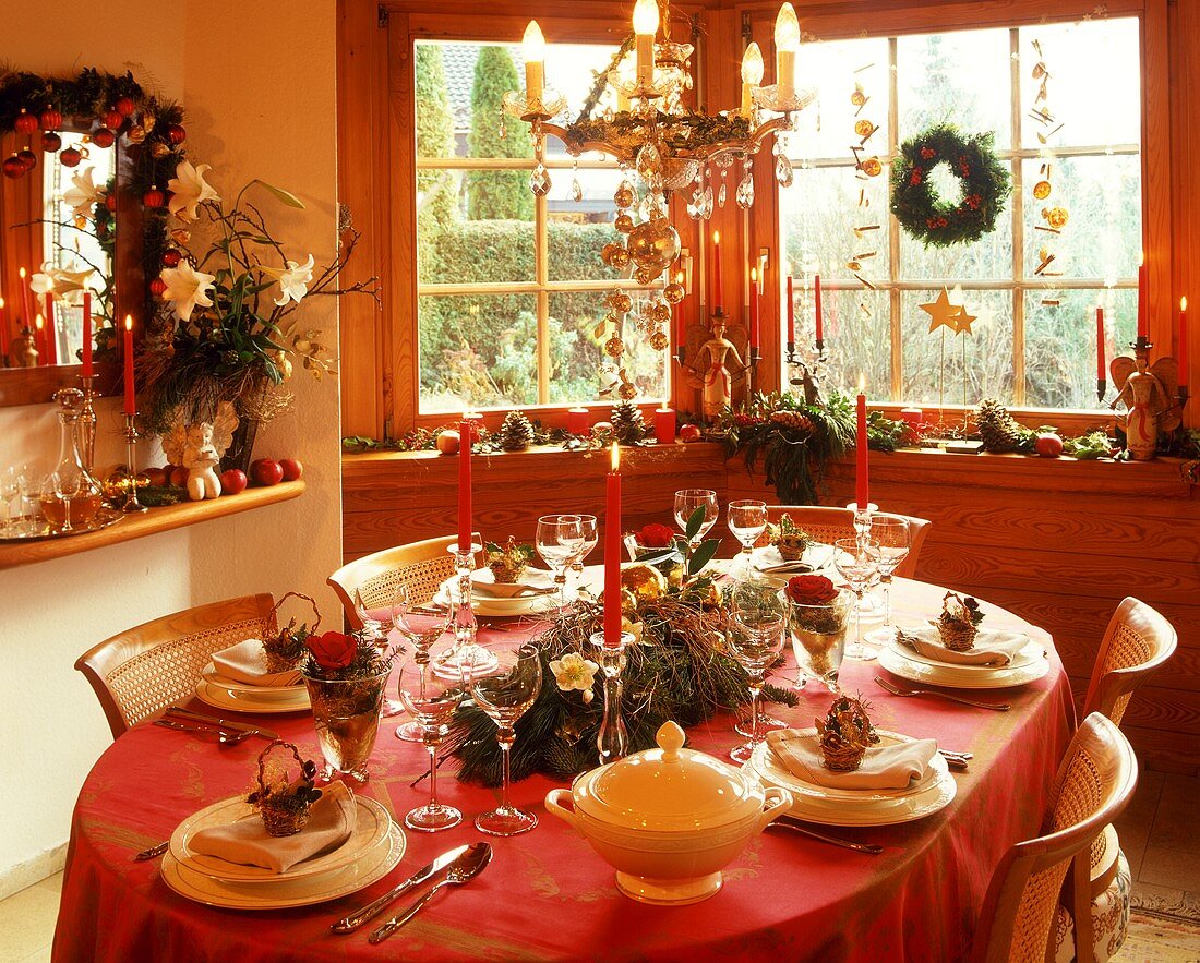 Weihnachtlich gedeckter Tisch mit Gesteck und Kerzen