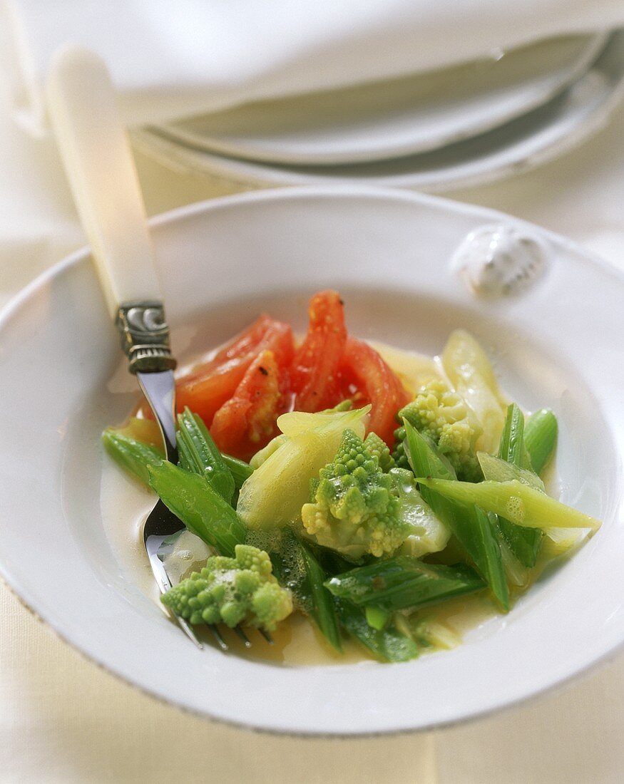 Plate of vegetables with Romanesco, celery and tomatoes