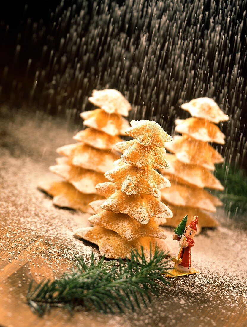 Fir trees made from star biscuits with icing sugar snow