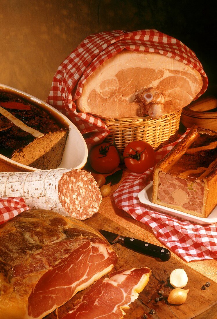 Still life with two French hams, sausage and pate