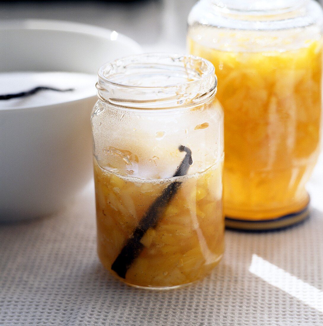 Pouring peach and pineapple jam into jars