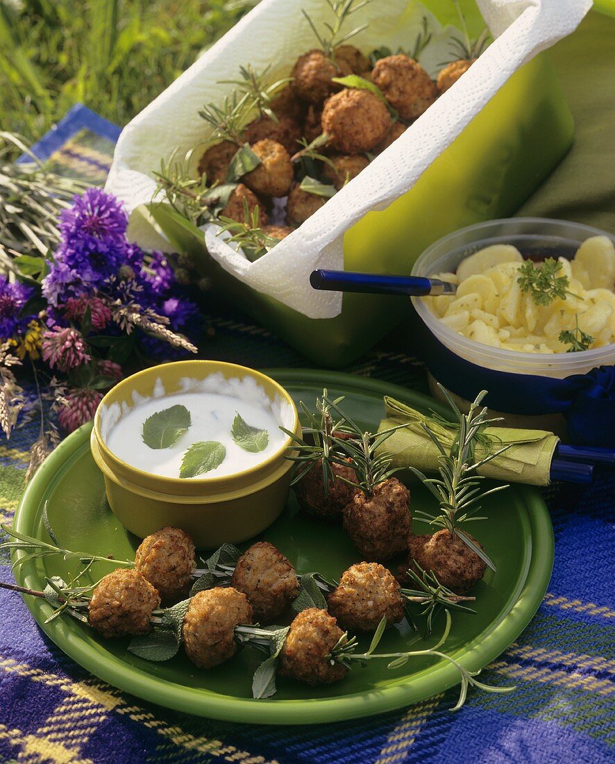 Meatballs skewered on rosemary with minted yoghurt dip