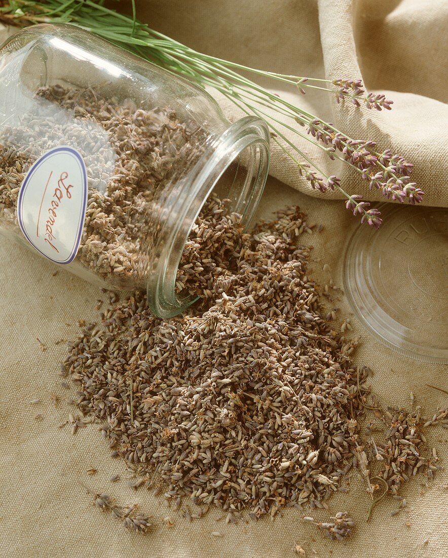 Dried lavender flowers falling out of a glass