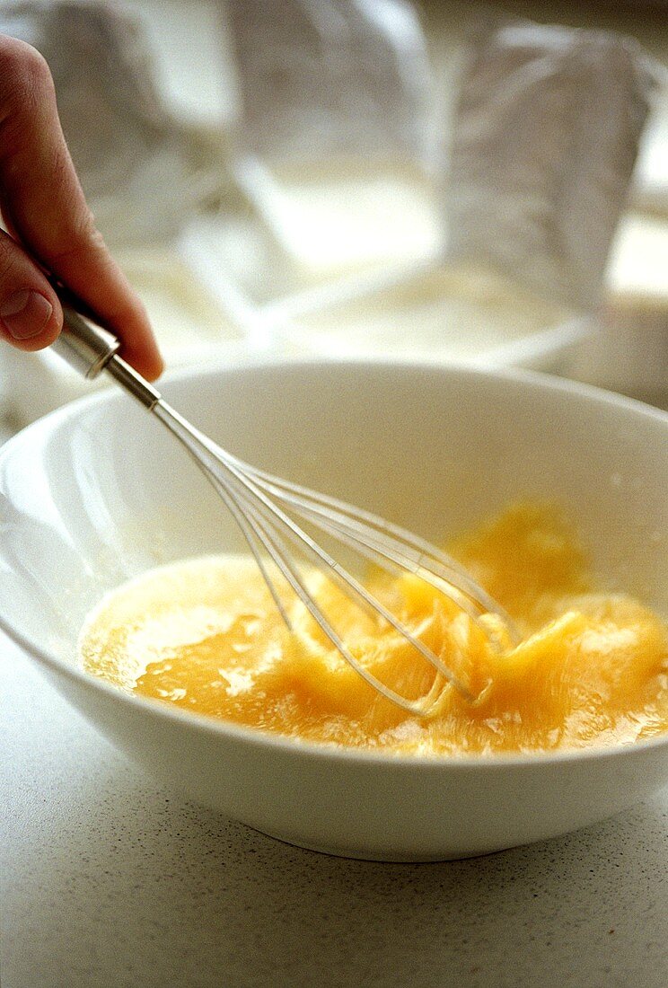 Whisking eggs in a bowl with a whisk