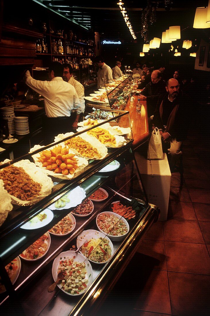 Various tapas in the counter display of a bar