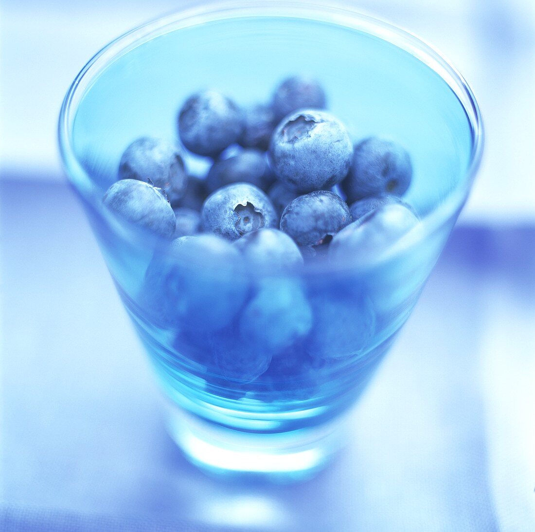 Blueberries in a blue glass
