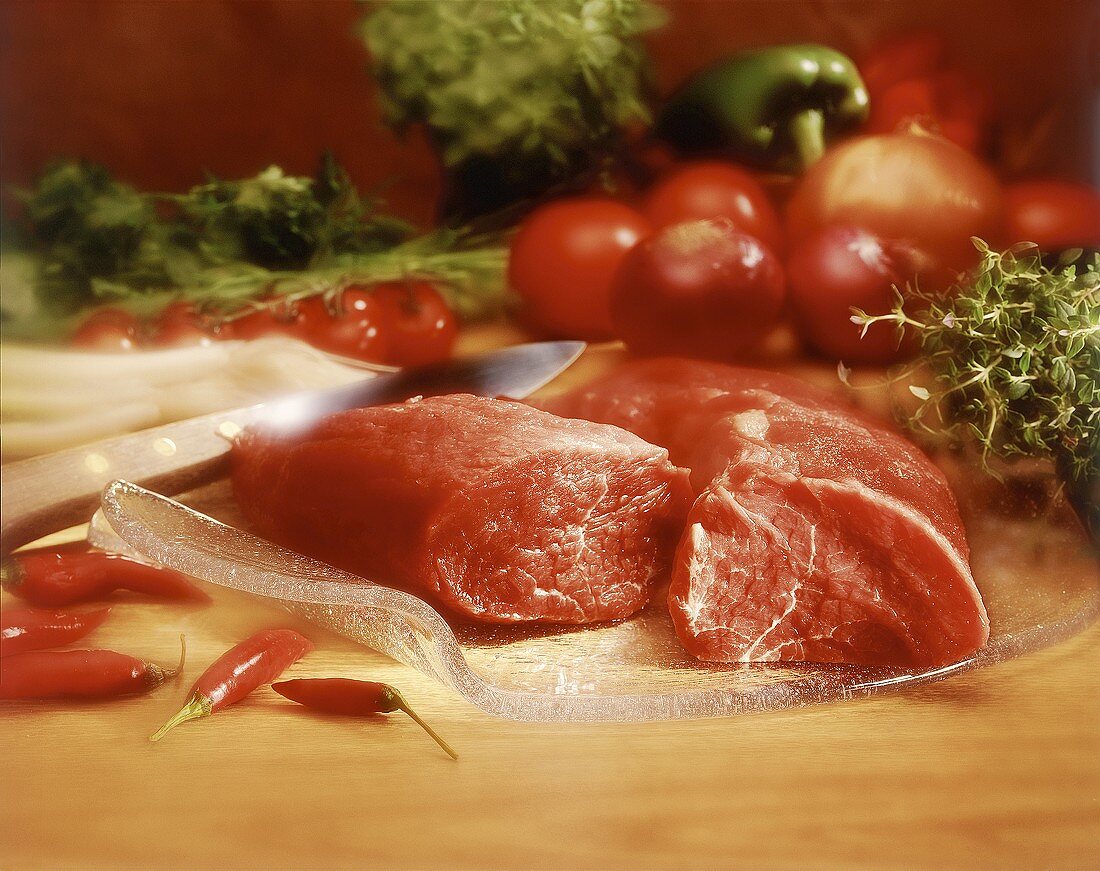 Beef fillet on a glass plate with vegetables