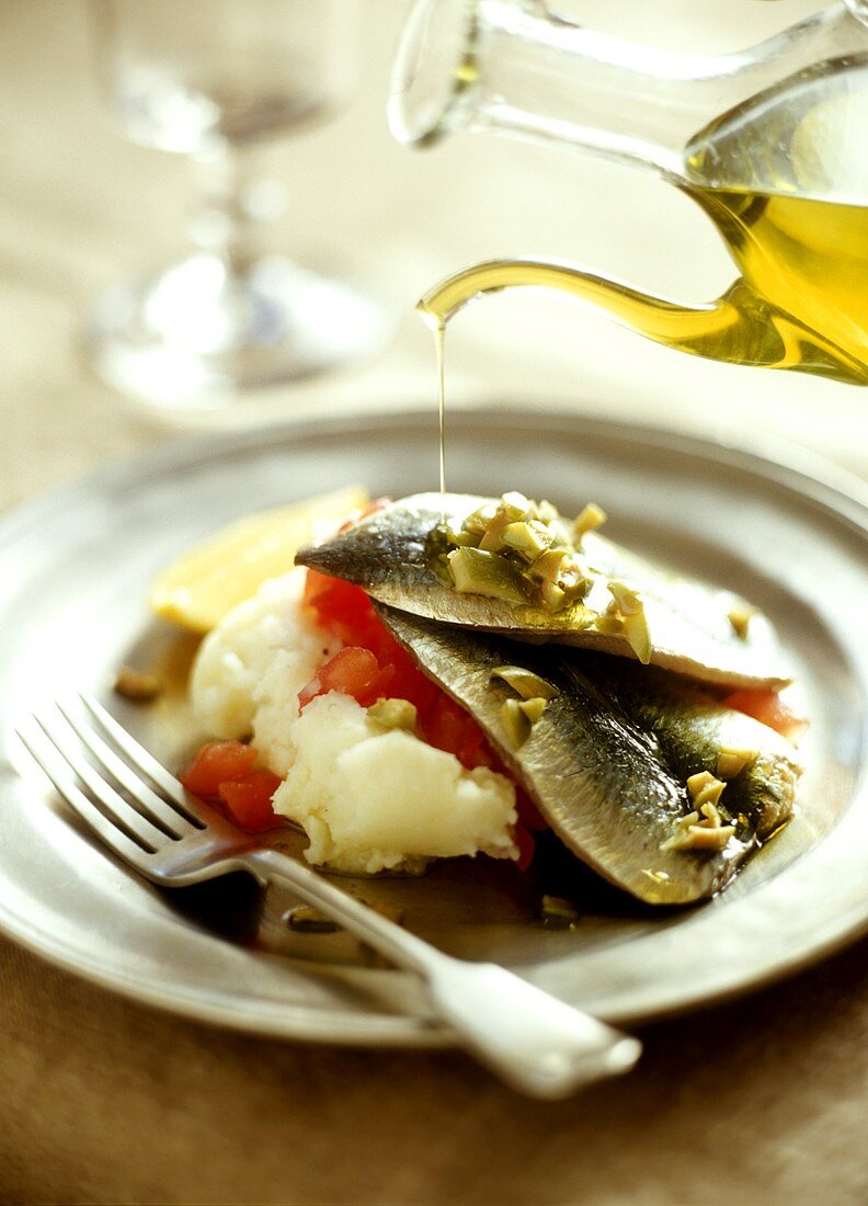 Marinated sardines with olive oil, mashed potato & tomatoes