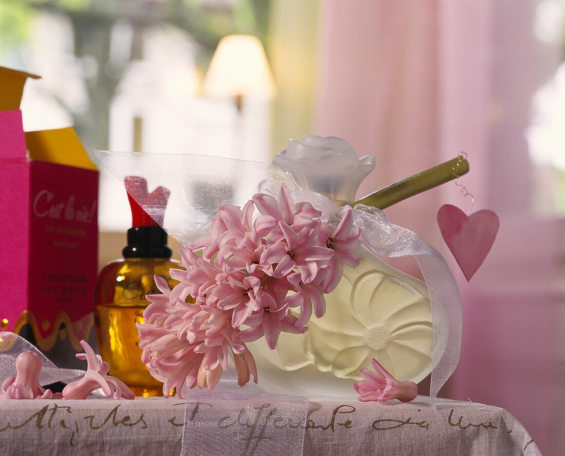 Perfume bottles, one with bow, hyacinth and heart