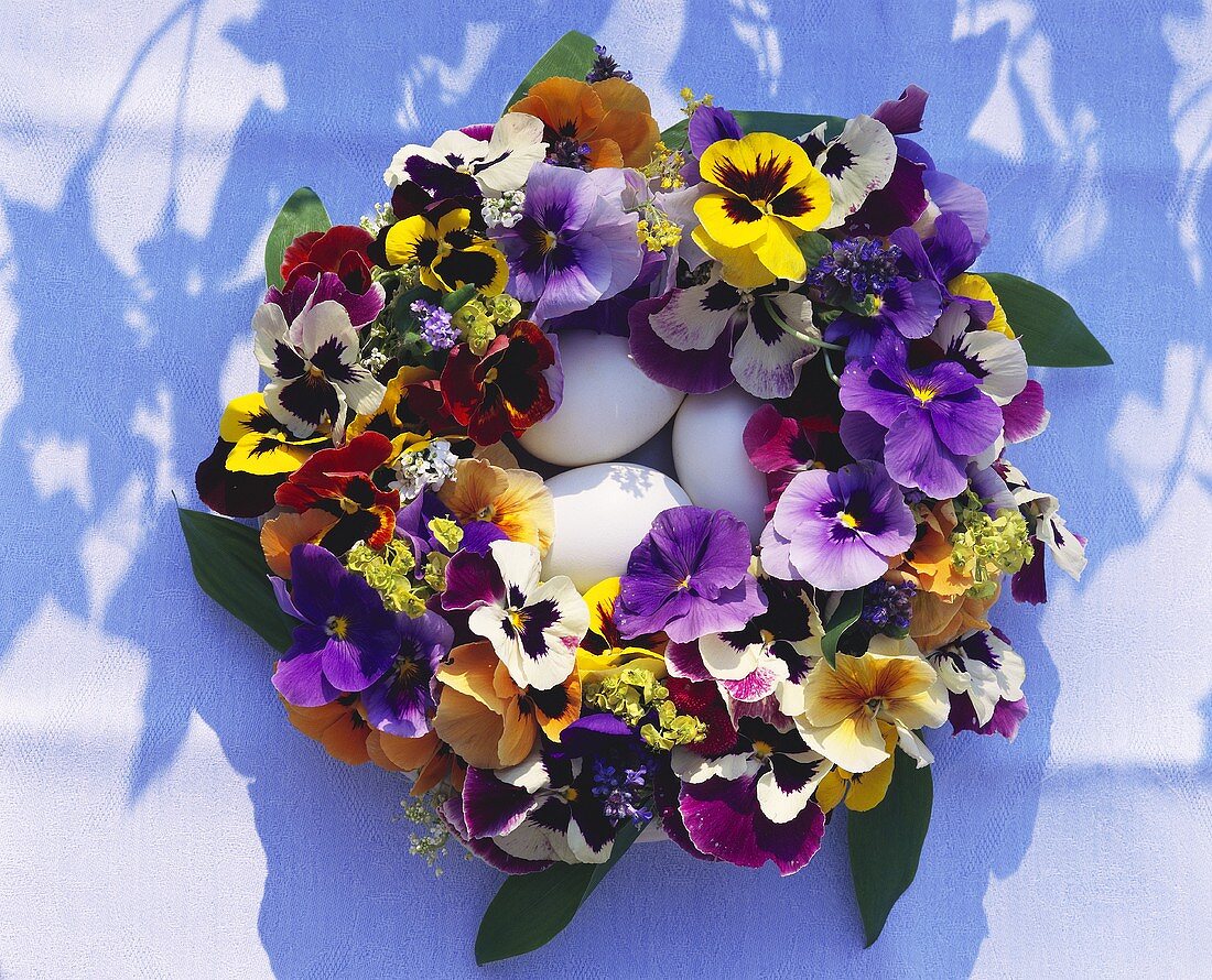 Easter wreath of pansies, three white eggs in the centre