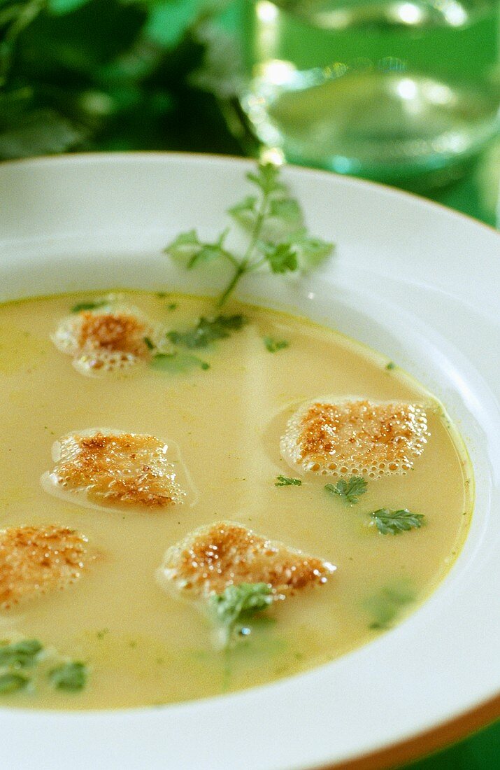 Potato and herb soup with croutons