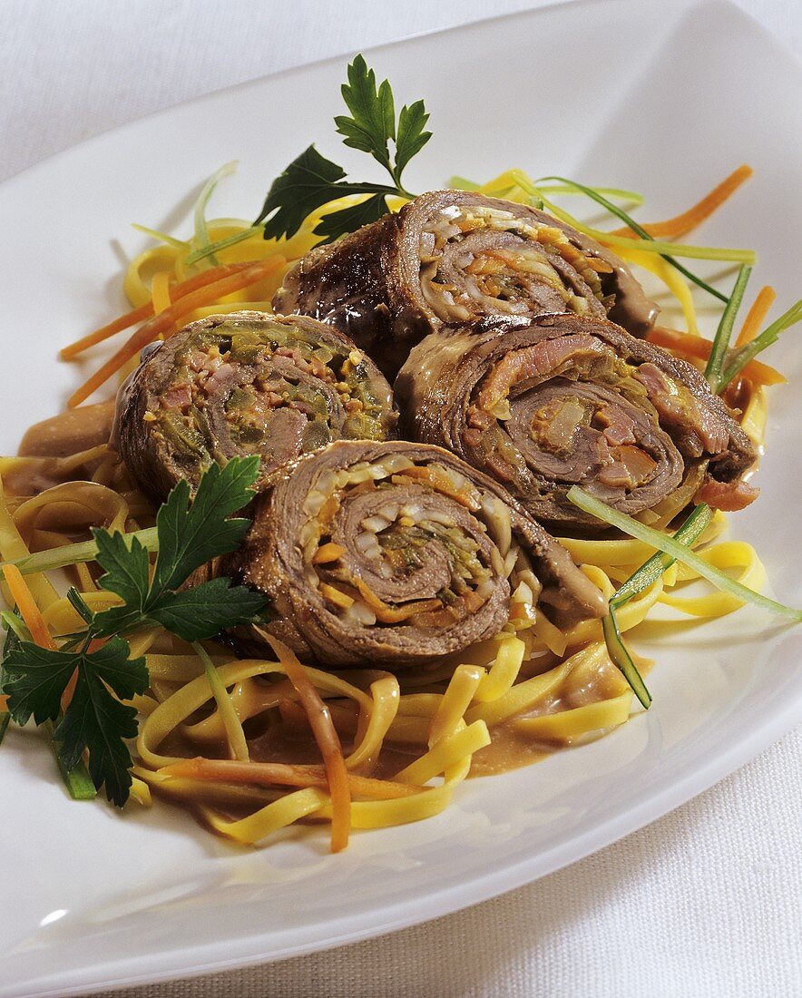Stuffed beef roulades on julienne vegetables