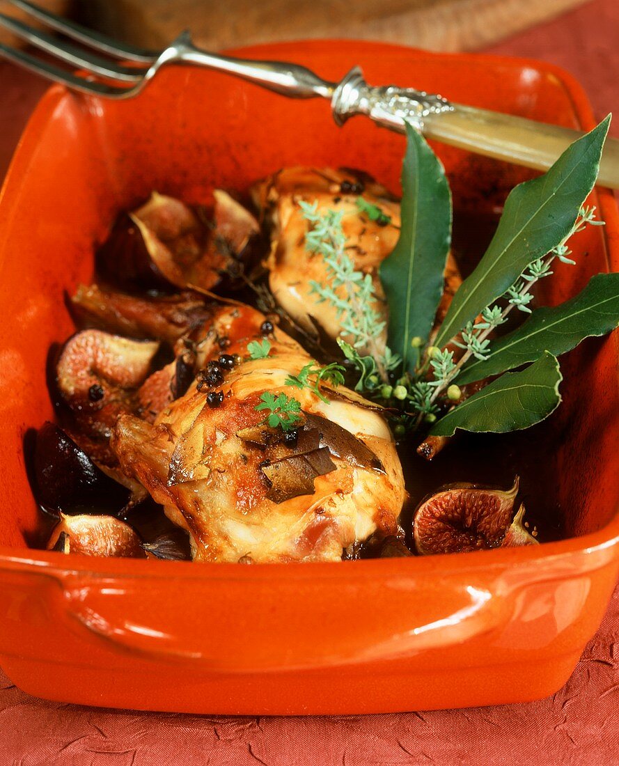 Braised rabbit leg with figs in roasting dish
