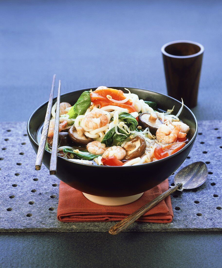 Asian miso soup with shrimps, shiitake, noodles, vegetables