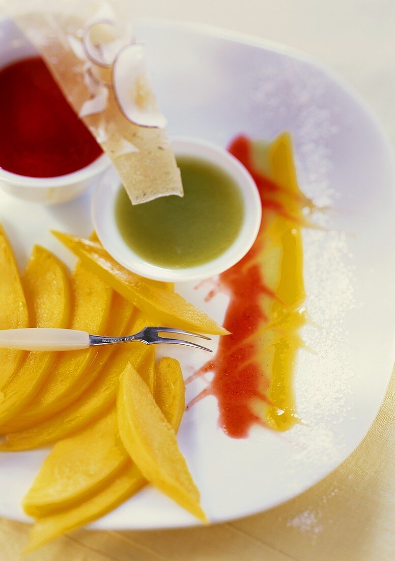 Mango slices with fruit sauces