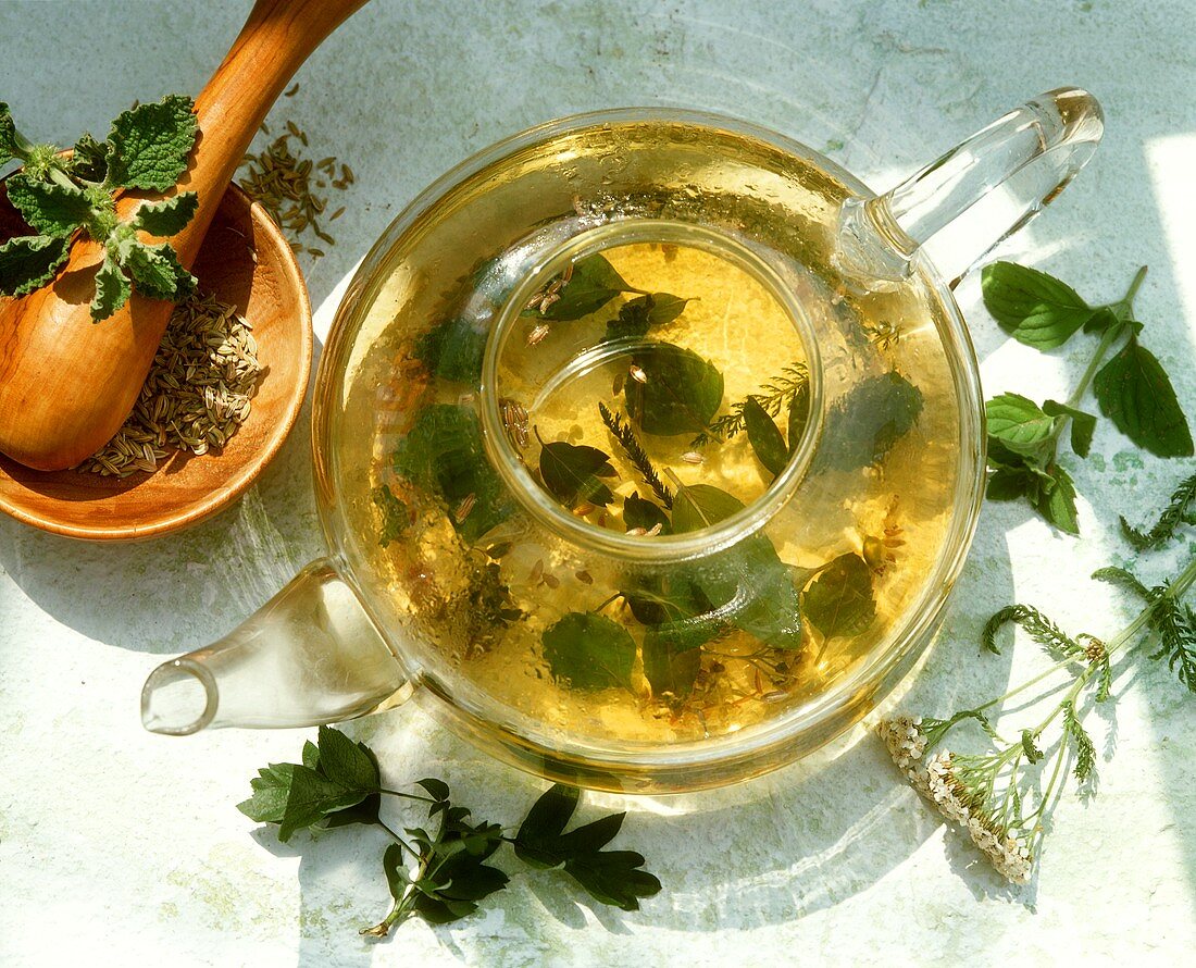 Herb tea infusing in a glass pot