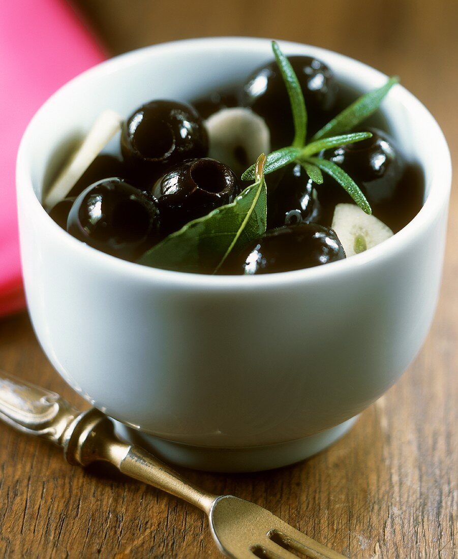 Black, stoned olives in a bowl
