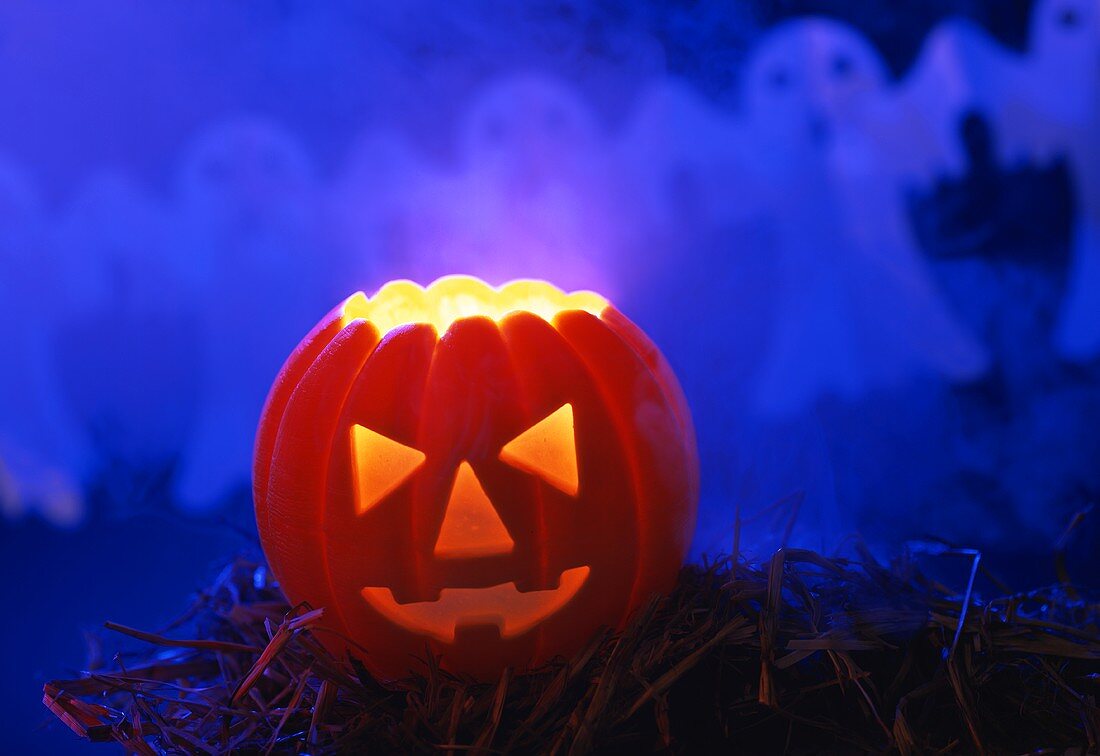 Pumpkin lantern for Halloween on straw