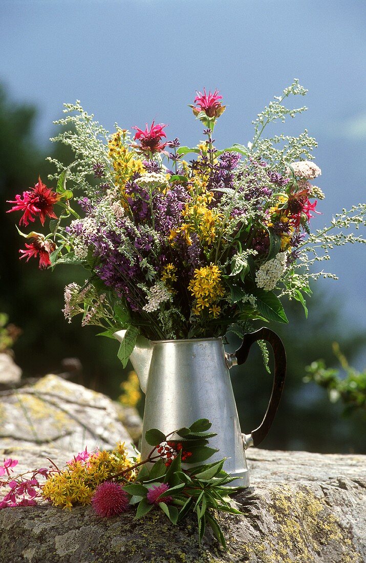 Bunch of wild herbs in a metal jug