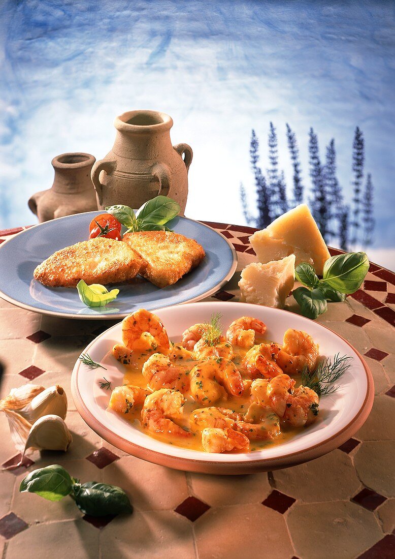 Shrimps in saffron sauce and breaded fish fillets