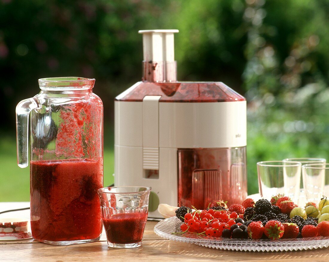 Freshly squeezed berry juice with juicer
