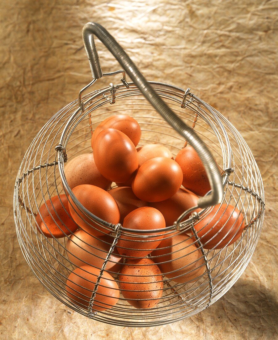 Brown eggs in wire basket