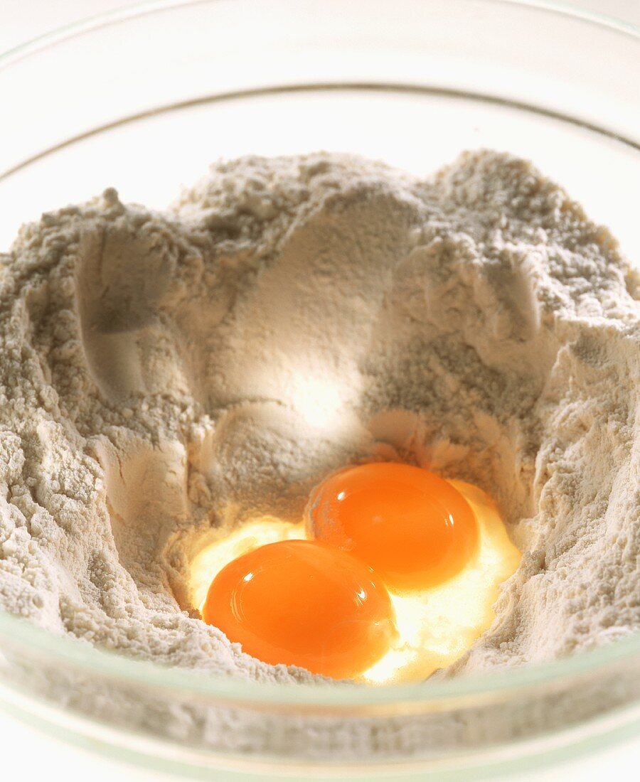 Depression in flour with two eggs