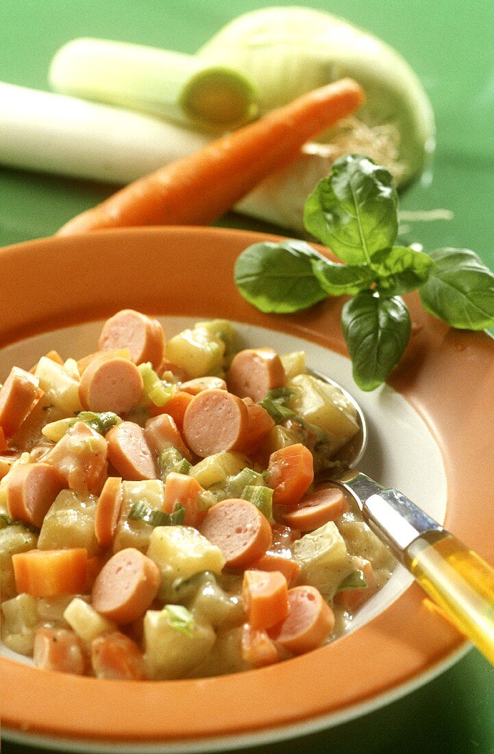 Spring vegetable stew with sausages