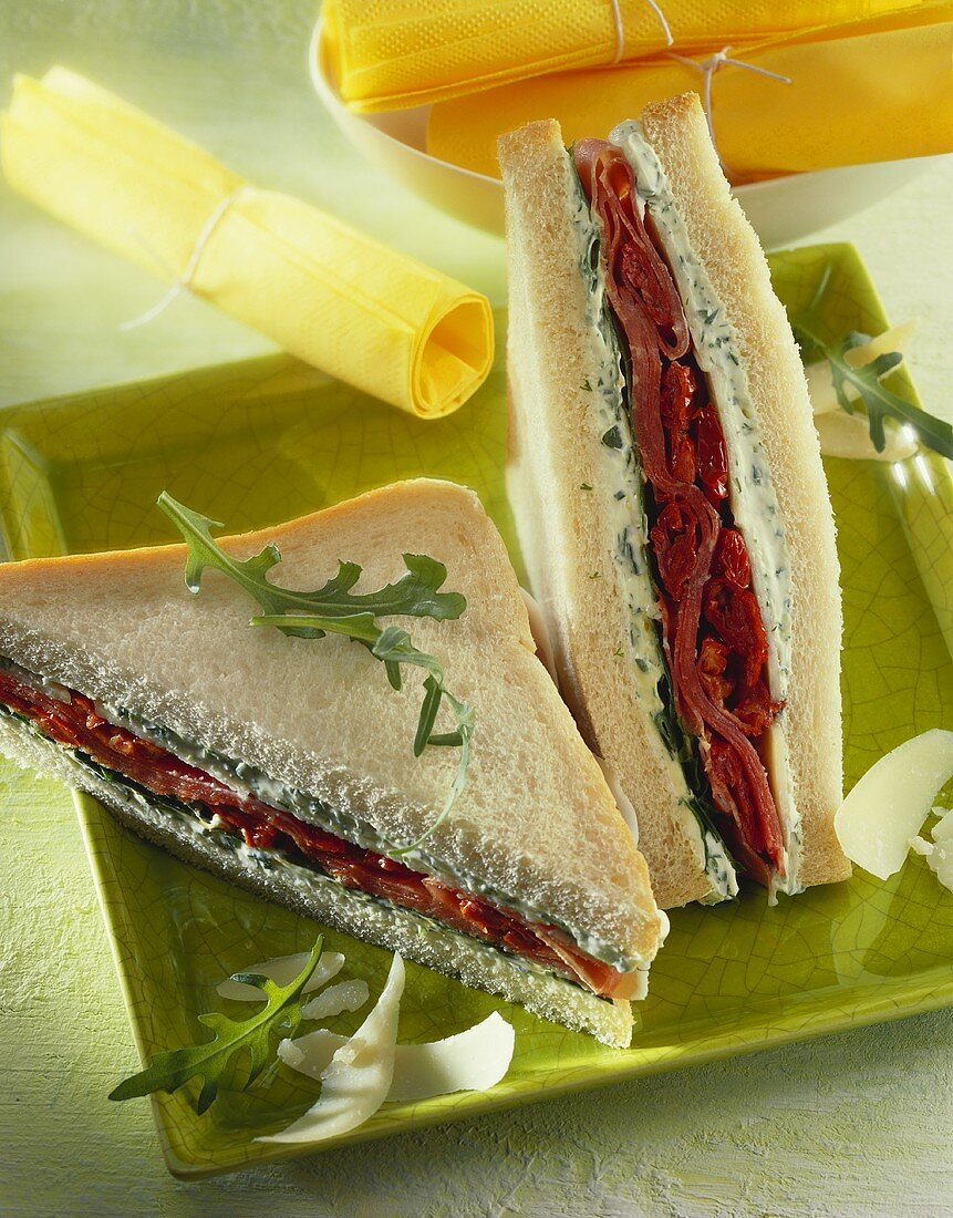 Tramezzino (herb spread and dried tomatoes in a sandwich)