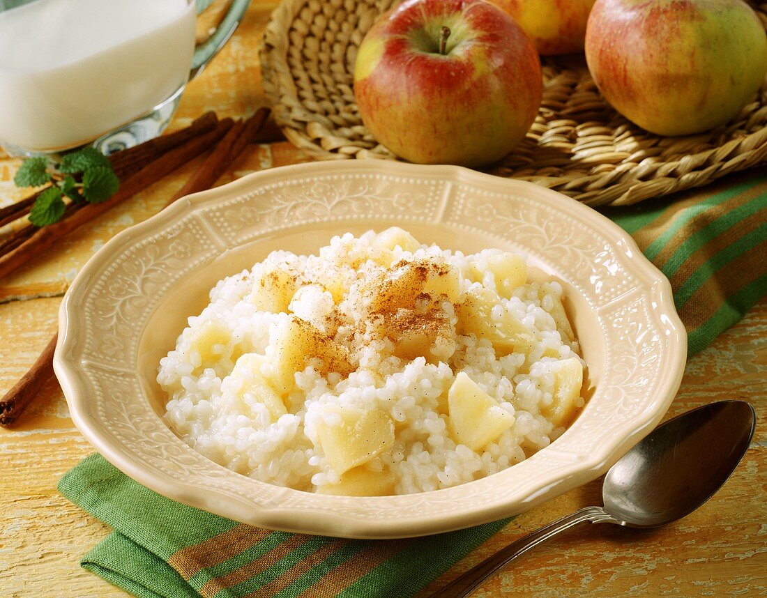 Apple rice pudding with cinnamon and sugar on plate
