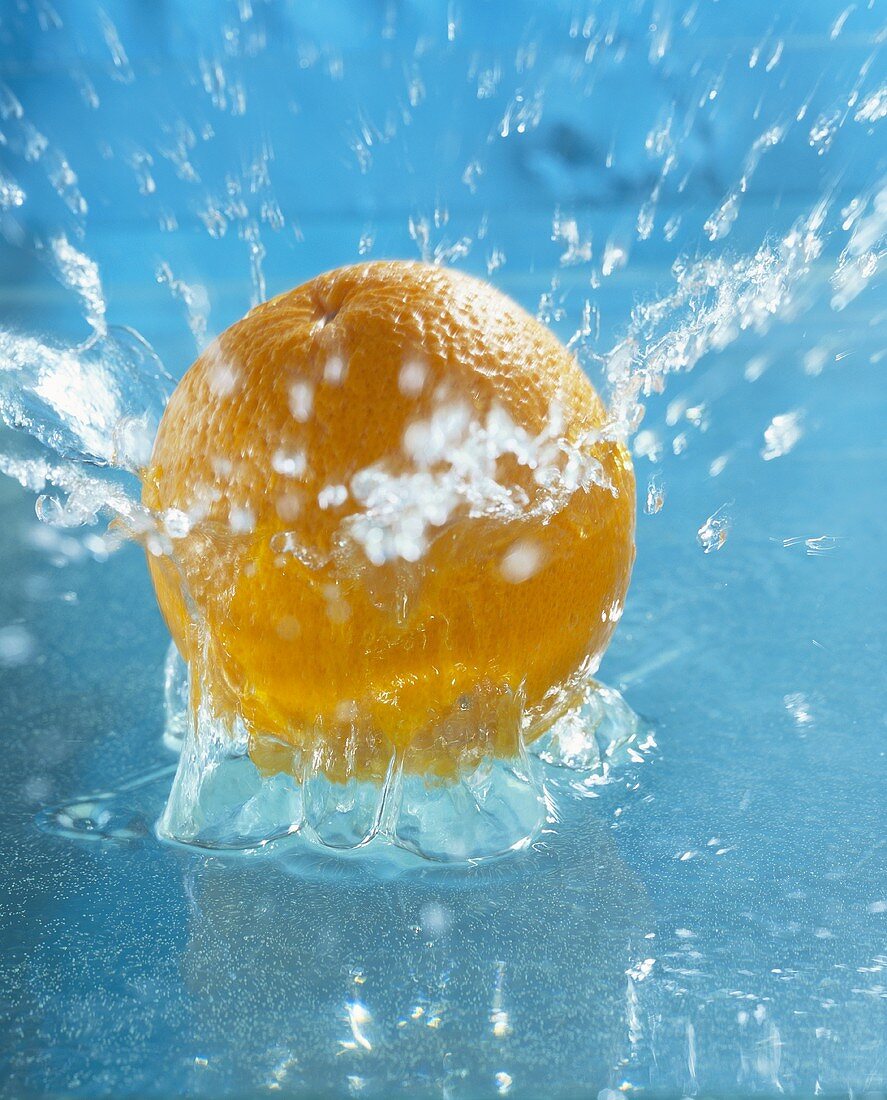 Orange falling into water