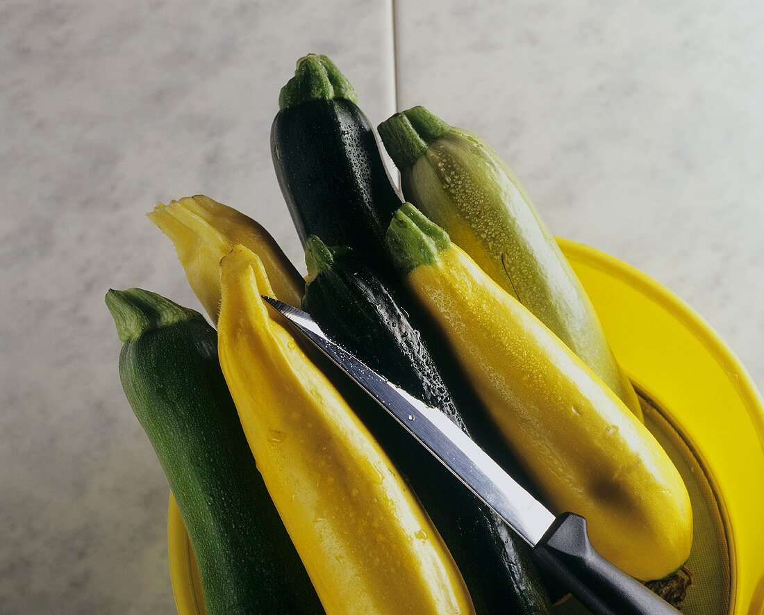 Various types of courgettes and a knife