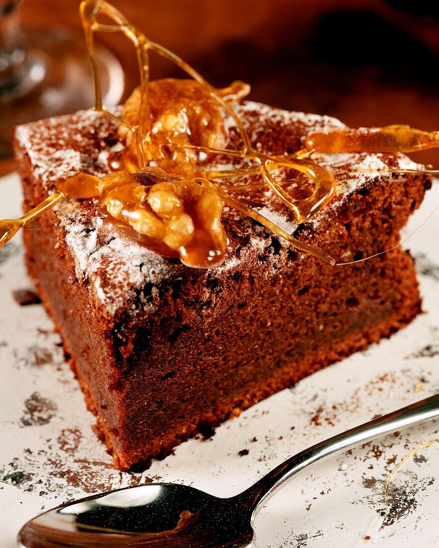 Piece of chocolate cake decorated with spun caramel & nuts