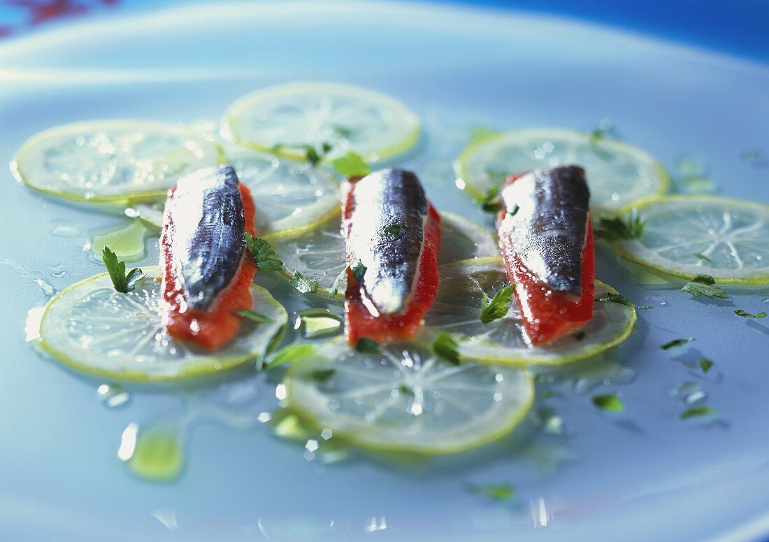 Marinated sardines on pieces of red pepper & lemon slices
