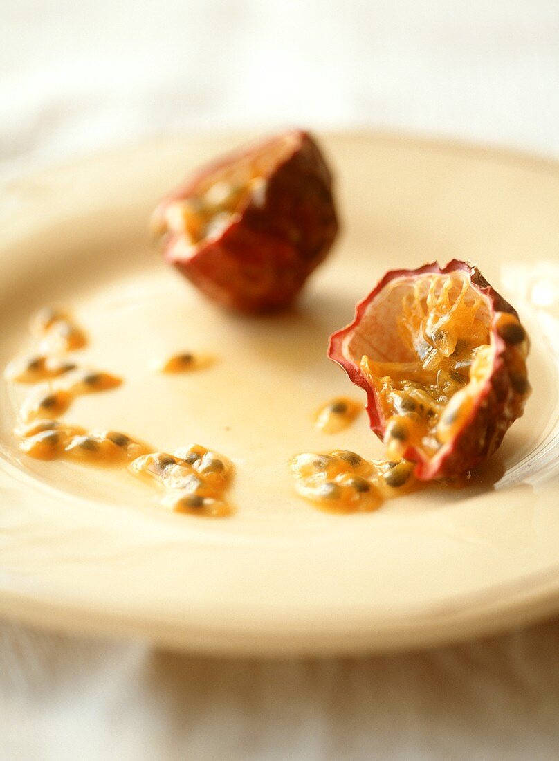 Two passion fruit halves on a plate