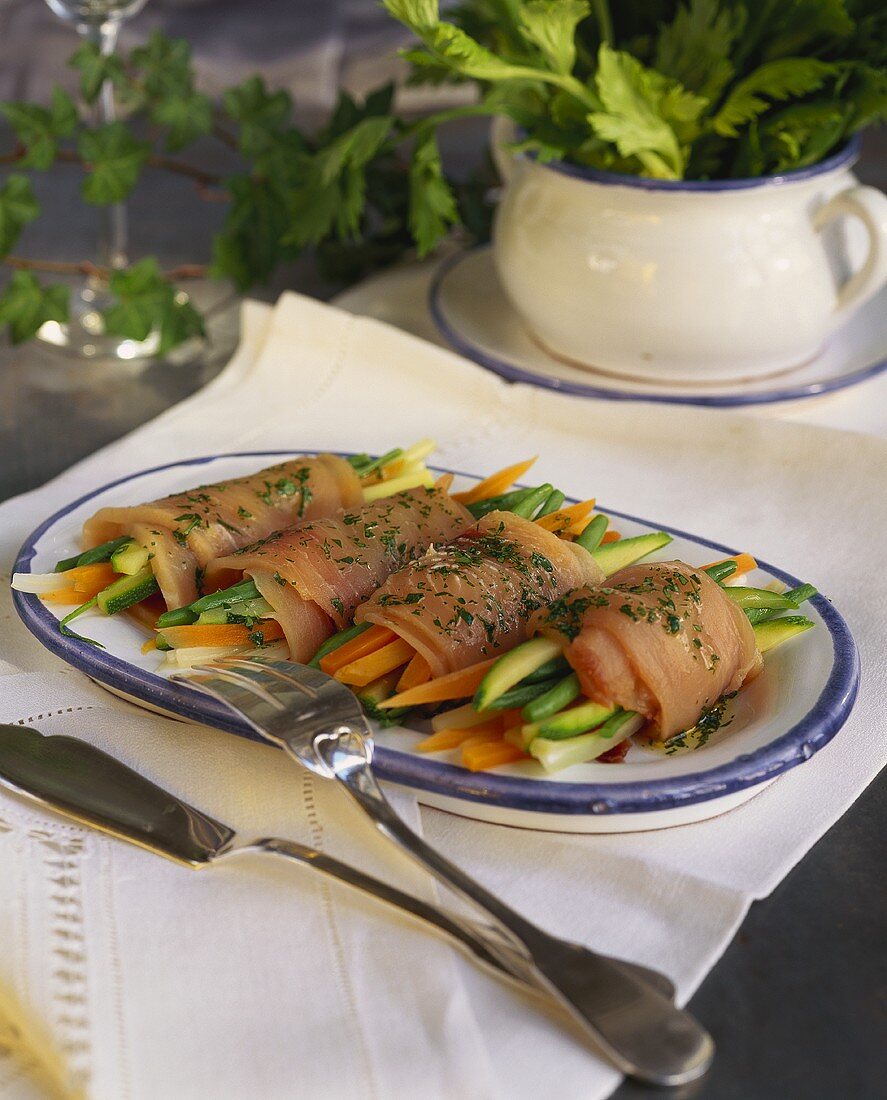 Swordfish rolls filled with strips of vegetables