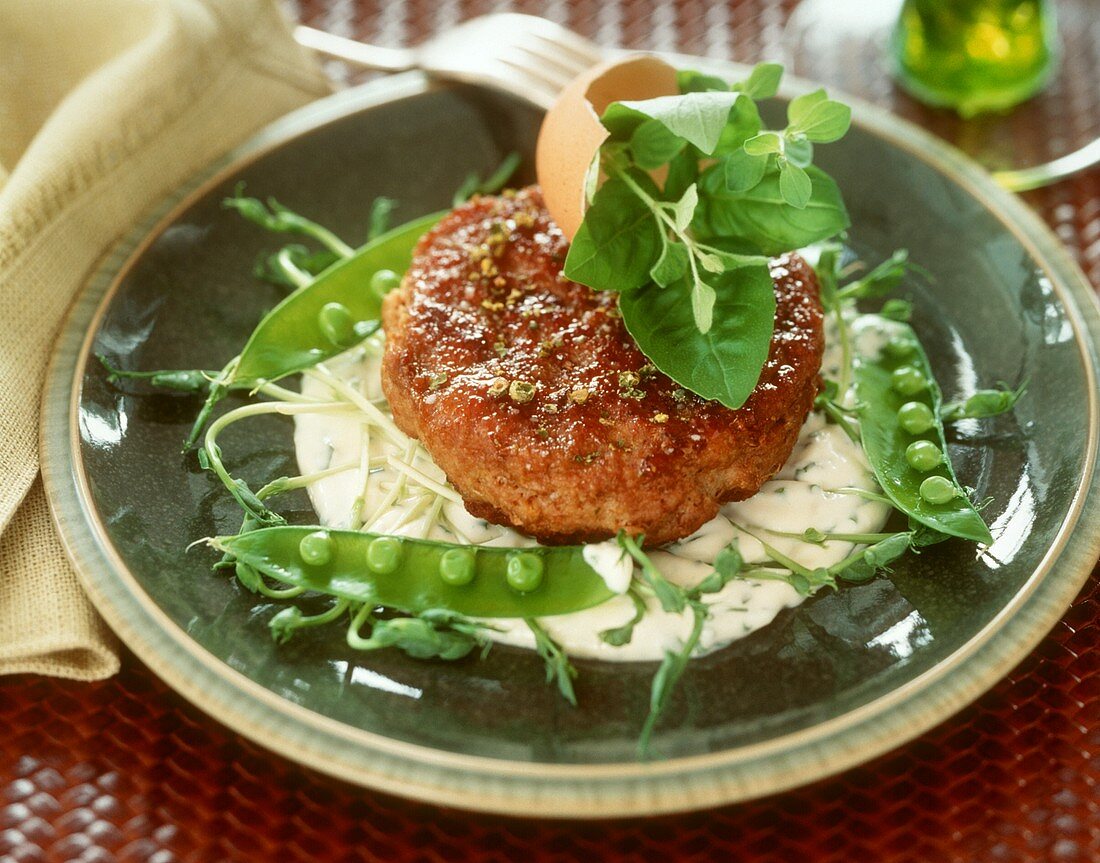 Rissole on pea sprouts and mayonnaise