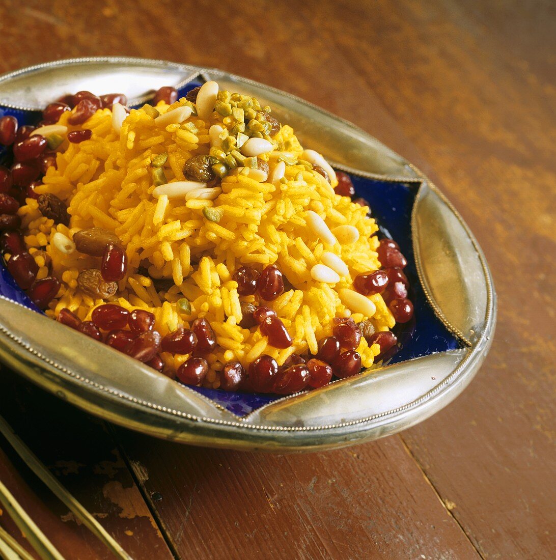 Yellow rice with turmeric, pine nuts and pomegranate