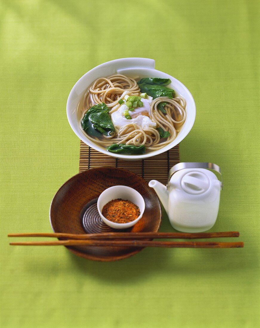 Soup with soba noodles, spinach and poached egg (Japan)