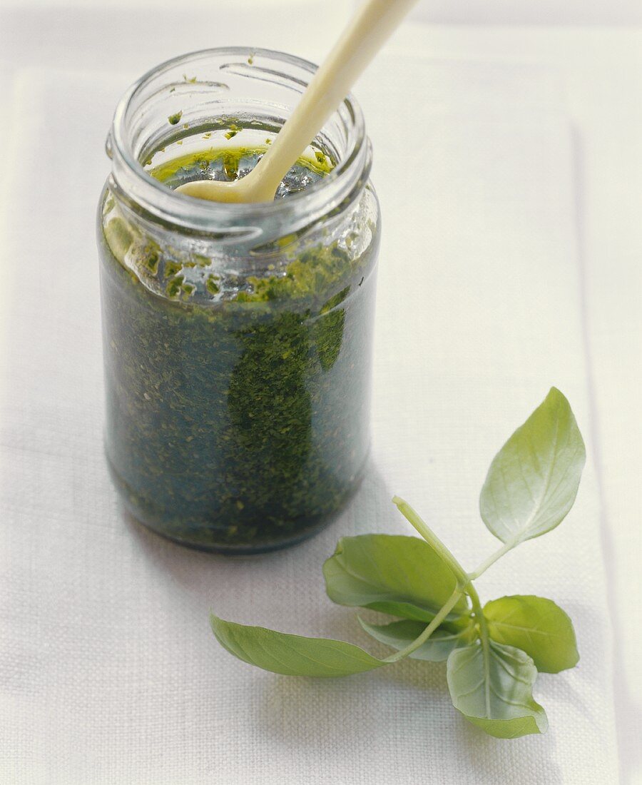 Pesto in glass with fresh basil leaves