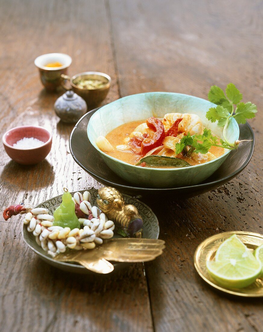 Fish curry in small bowl with Asian decoration