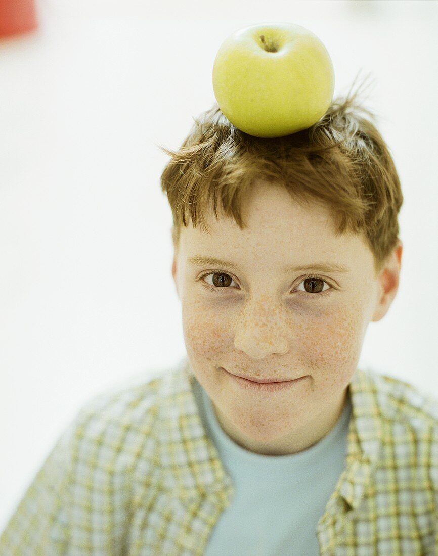 Boy with apple on his head