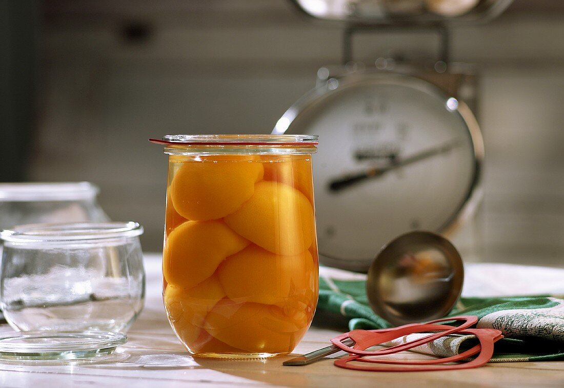 Bottled peach halves in jar