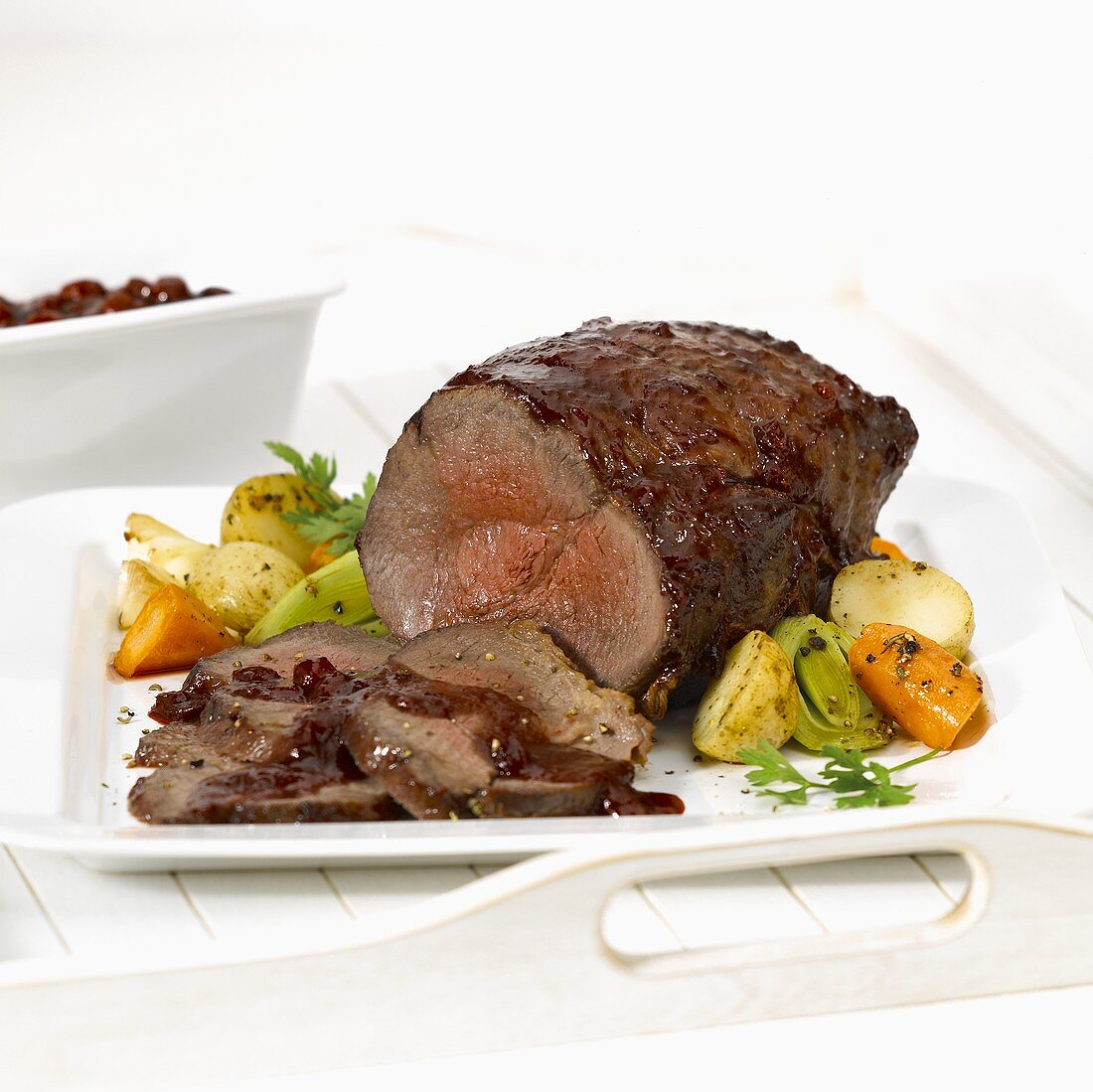 Barbecued roast beef, slices carved, with vegetables
