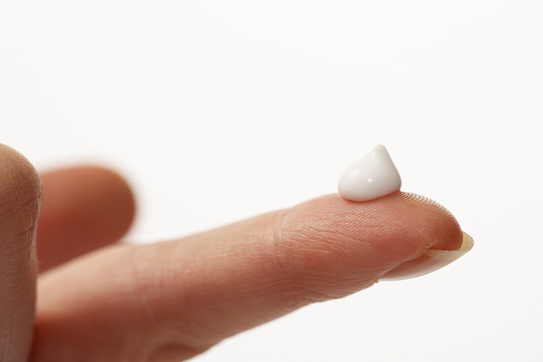 A drop of cream on a fingertip
