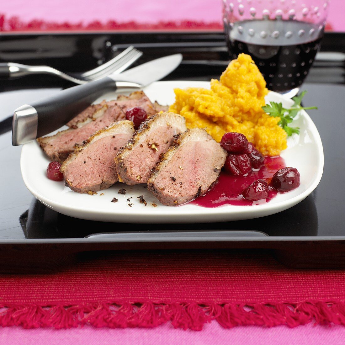 Sliced duck breast with cherries & mashed sweet potatoes