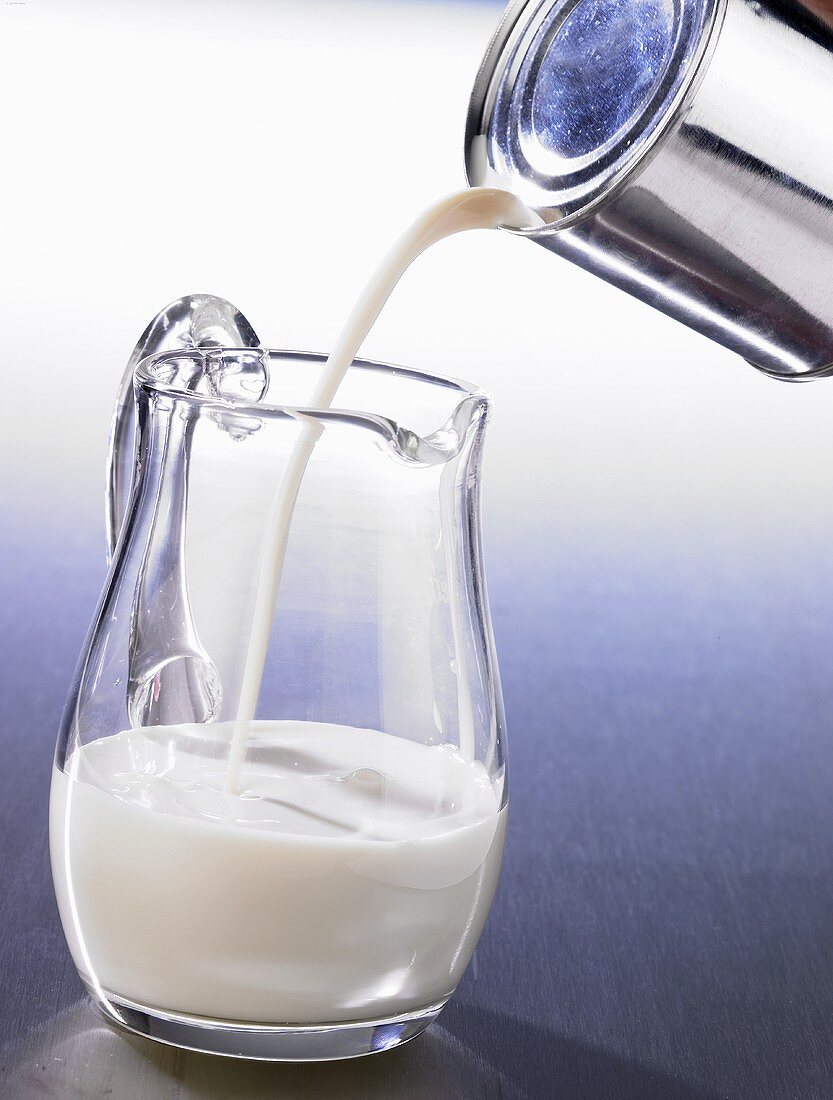 Pouring tinned milk into a jug