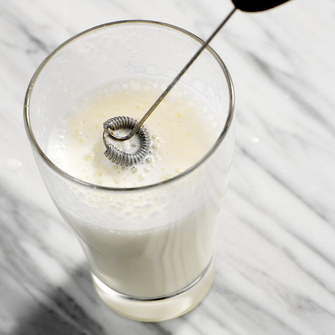 Frothing milk with spiral whisk